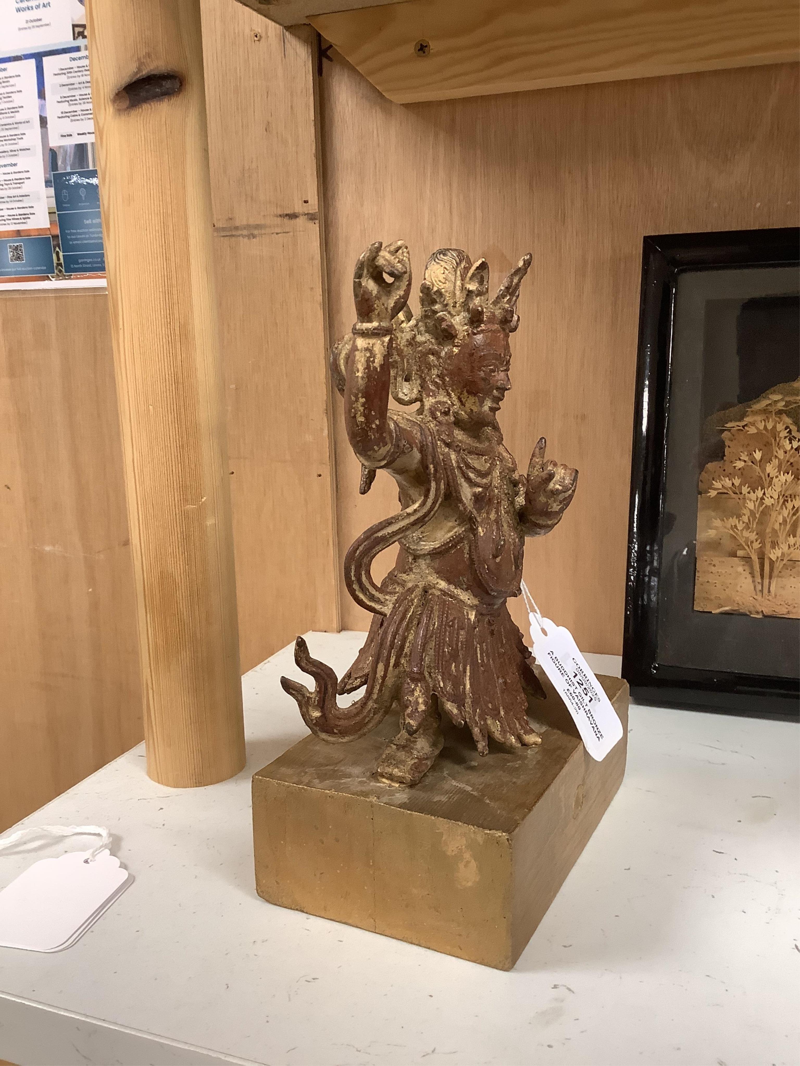 A Buddhist gilt bronze figure of Vaishravana, possibly Tibetan, 21 cm including wooden stand.